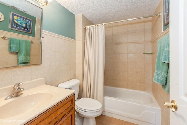 511 Aurora Ave Unit 405, Naperville, IL 60540 - bathroom with tile walls, vanity, shower / bath combination with curtain, a textured ceiling, and tile patterned floors