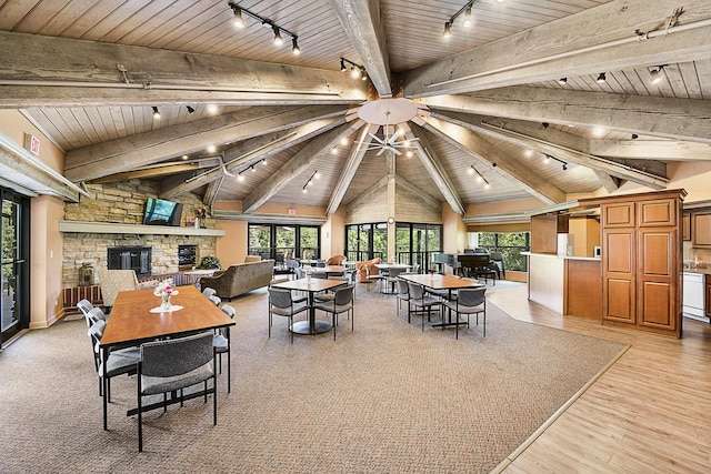 511 Aurora Ave Unit 405, Naperville, IL 60540 - dining area with rail lighting, wood ceiling, a fireplace, and light wood-style floors