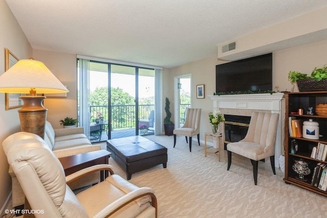 511 Aurora Ave Unit 405, Naperville, IL 60540 - living room featuring carpet floors, a glass covered fireplace, floor to ceiling windows, and a textured ceiling