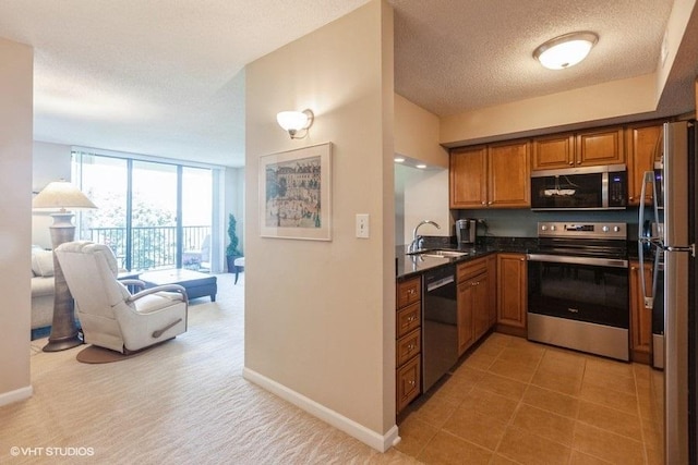 511 Aurora Ave Unit 405, Naperville, IL 60540 - kitchen featuring appliances with stainless steel finishes, brown cabinetry, a wall of windows, and a textured ceiling