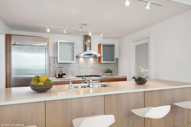 340 E Randolph St Unit 803, Chicago, IL 60601 - kitchen featuring wall chimney exhaust hood, built in fridge, track lighting, tasteful backsplash, and modern cabinets