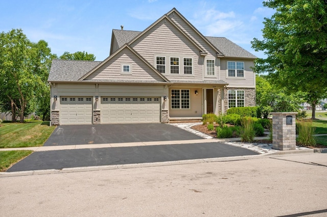 619 Northgate Dr, Sycamore, IL 60178 - view of front of house featuring stone siding, driveway, and a garage