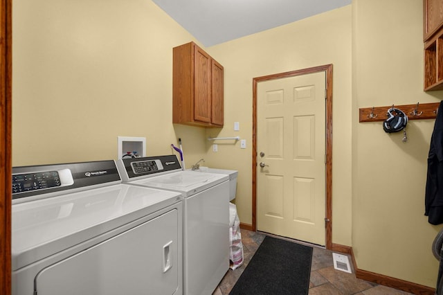 619 Northgate Dr, Sycamore, IL 60178 - washroom featuring cabinet space, washing machine and dryer, and dark stone finish flooring