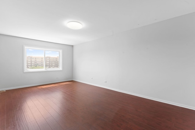 4900 Foster St Unit 410, Skokie, IL 60077 - empty room featuring dark wood-style floors and baseboards