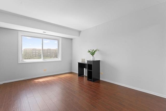 4900 Foster St Unit 410, Skokie, IL 60077 - spare room featuring baseboards and dark wood-style flooring