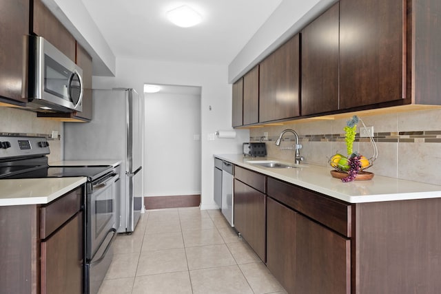 4900 Foster St Unit 410, Skokie, IL 60077 - kitchen with appliances with stainless steel finishes, tasteful backsplash, light tile patterned floors, and light countertops