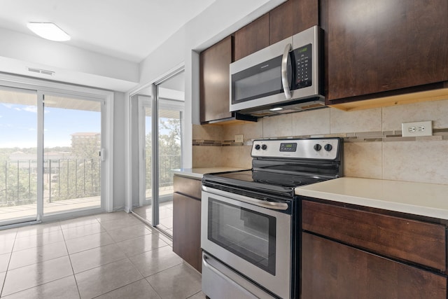 4900 Foster St Unit 410, Skokie, IL 60077 - kitchen featuring stainless steel appliances, healthy amount of natural light, decorative backsplash, and light countertops