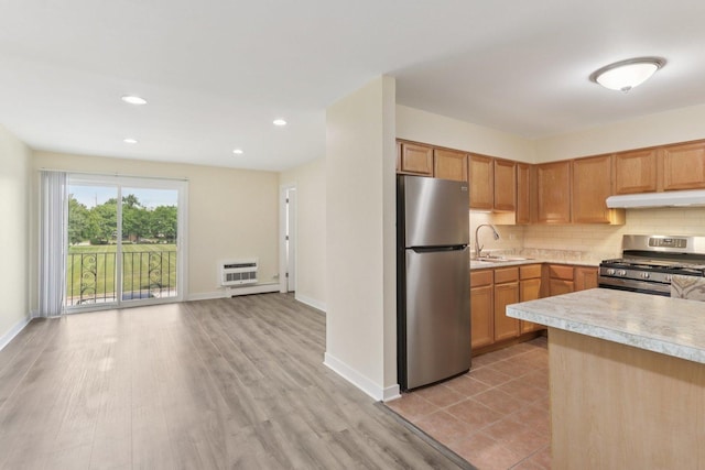 9250 Noel Ave Unit 205E, Des Plaines, IL 60016 - kitchen with stainless steel appliances, under cabinet range hood, light countertops, decorative backsplash, and open floor plan