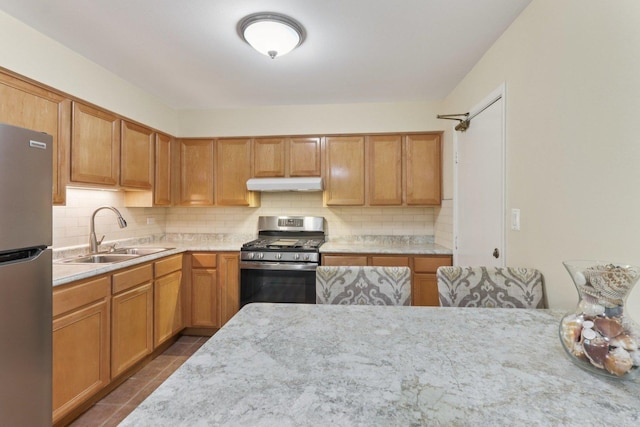 9250 Noel Ave Unit 205E, Des Plaines, IL 60016 - kitchen with appliances with stainless steel finishes, under cabinet range hood, decorative backsplash, and dark tile patterned flooring