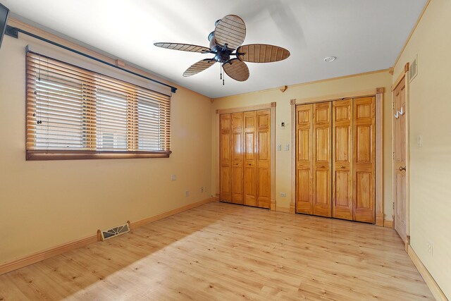 7637 Sequoia Ct, Orland Park, IL 60462 - unfurnished bedroom with two closets, light wood-style floors, and ceiling fan