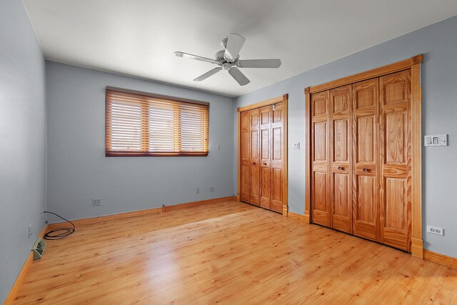 7637 Sequoia Ct, Orland Park, IL 60462 - unfurnished bedroom featuring two closets, light wood-type flooring, and ceiling fan
