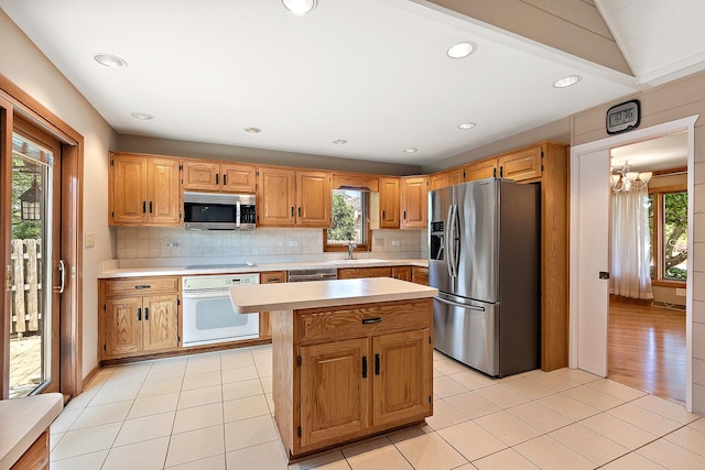 7637 Sequoia Ct, Orland Park, IL 60462 - kitchen featuring appliances with stainless steel finishes, light countertops, tasteful backsplash, a kitchen island, and recessed lighting