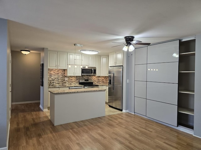 836 E Old Willow Rd Unit 109, Prospect Heights, IL 60070 - kitchen featuring stainless steel appliances, a ceiling fan, light wood-style flooring, backsplash, and light stone countertops