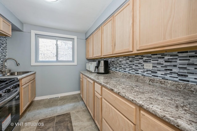 1147 E 91st St, Chicago, IL 60638 - kitchen featuring light brown cabinets, gas stove, decorative backsplash, light stone countertops, and stone finish flooring