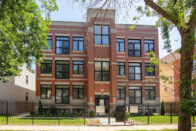 633 E Bowen Ave Unit 1E, Chicago, IL 60653 - view of front of house featuring brick siding and a fenced front yard