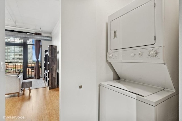 212 E Cullerton St Unit 702, Chicago, IL 60616 - laundry room featuring stacked washer / dryer and light wood-style flooring