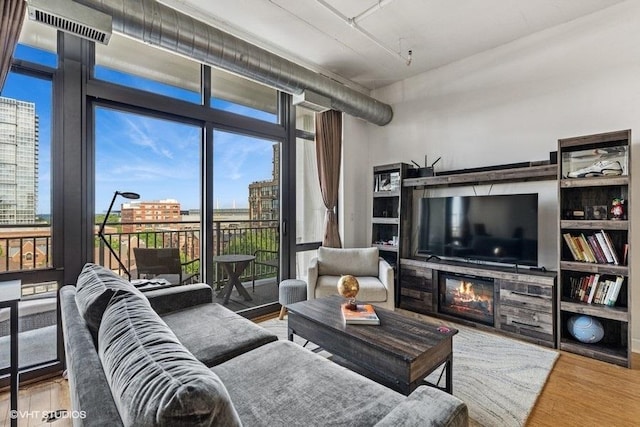 212 E Cullerton St Unit 702, Chicago, IL 60616 - living area featuring wood finished floors and a glass covered fireplace
