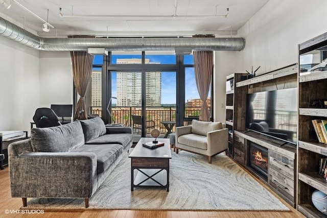 212 E Cullerton St Unit 702, Chicago, IL 60616 - living area featuring wood finished floors and a glass covered fireplace