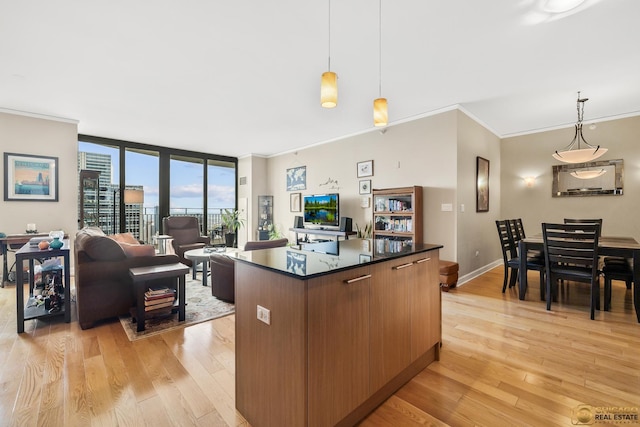 225 N Columbus Dr Unit 6808, Chicago, IL 60601 - kitchen with light wood-style flooring, dark countertops, a center island, crown molding, and pendant lighting