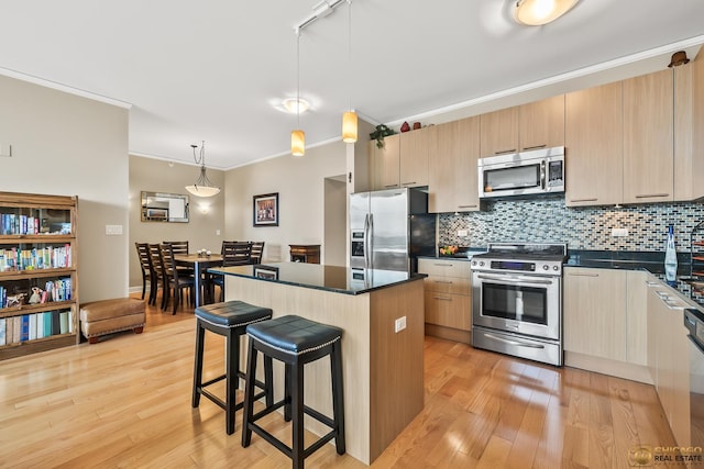 225 N Columbus Dr Unit 6808, Chicago, IL 60601 - kitchen with stainless steel appliances, crown molding, a breakfast bar area, a center island, and tasteful backsplash