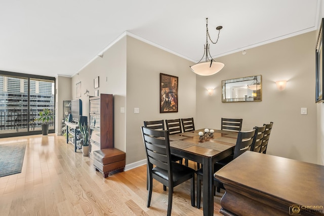 225 N Columbus Dr Unit 6808, Chicago, IL 60601 - dining room featuring a wall of windows, ornamental molding, and light wood-style flooring