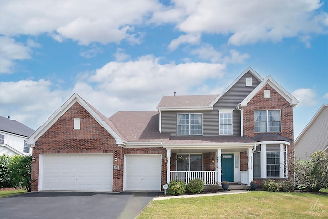 414 Alden Dr, Sycamore, IL 60178 - traditional home featuring a porch, brick siding, asphalt driveway, a garage, and a front yard