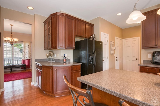 414 Alden Dr, Sycamore, IL 60178 - kitchen with light wood-type flooring, a kitchen breakfast bar, pendant lighting, a chandelier, and recessed lighting