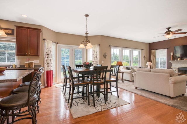 414 Alden Dr, Sycamore, IL 60178 - dining area with light wood finished floors, a ceiling fan, recessed lighting, a chandelier, and a fireplace