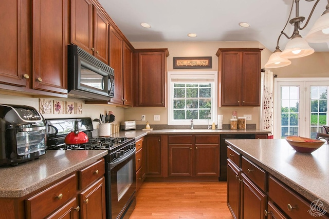 414 Alden Dr, Sycamore, IL 60178 - kitchen featuring black appliances, dark countertops, healthy amount of natural light, light wood-type flooring, and recessed lighting