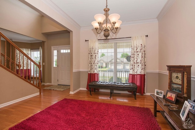 414 Alden Dr, Sycamore, IL 60178 - entrance foyer with a chandelier, wood finished floors, crown molding, and stairway