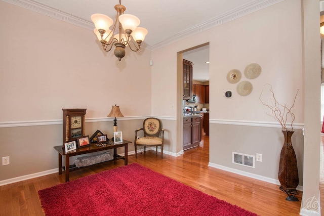 414 Alden Dr, Sycamore, IL 60178 - sitting room with a chandelier, light wood-style floors, and crown molding