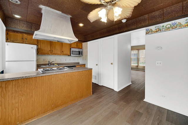 1746 Sessions Walk Unit 1746, Hoffman Estates, IL 60169 - kitchen featuring freestanding refrigerator, stainless steel microwave, premium range hood, brown cabinetry, and ceiling fan