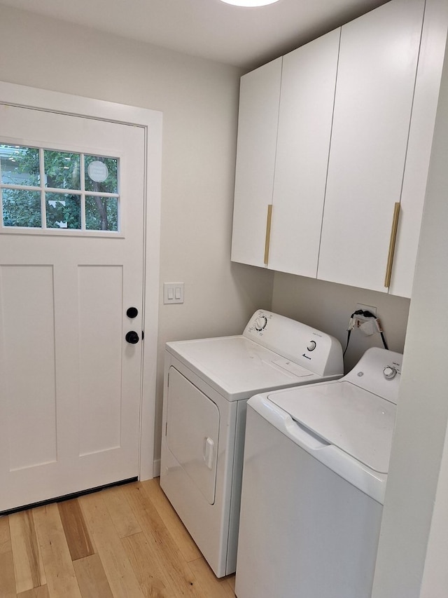 5841 Sunrise Ave, Clarendon Hills, IL 60514 - laundry area featuring cabinet space, washing machine and dryer, and light wood-type flooring