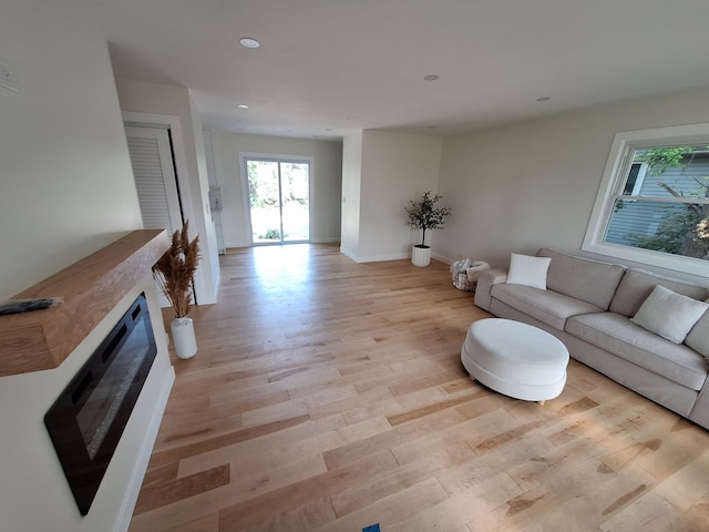 5841 Sunrise Ave, Clarendon Hills, IL 60514 - living room with light wood-style flooring, a glass covered fireplace, and recessed lighting