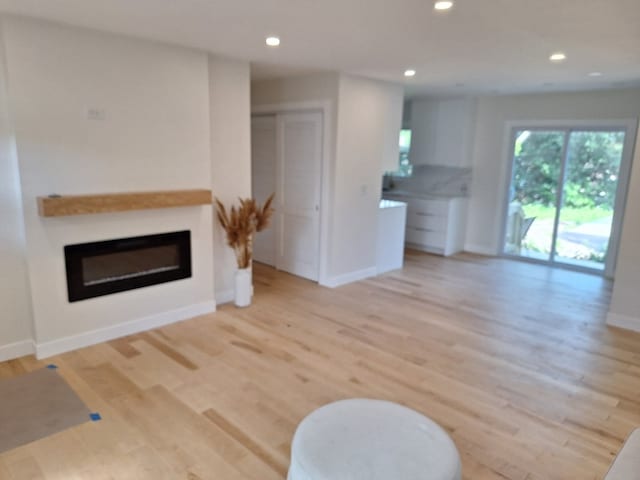 5841 Sunrise Ave, Clarendon Hills, IL 60514 - living area with a glass covered fireplace, light wood-type flooring, and recessed lighting