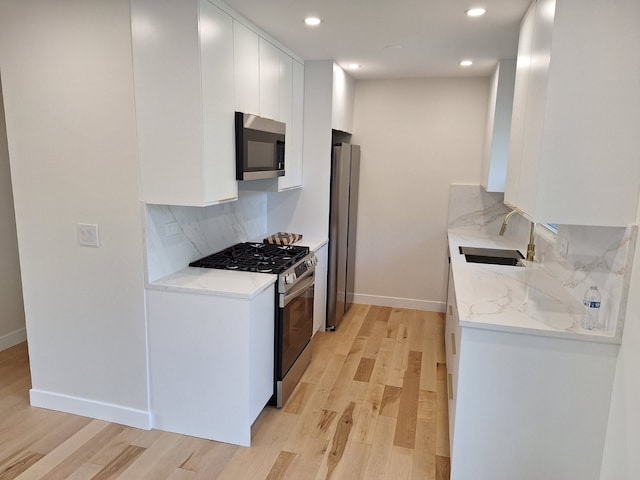 5841 Sunrise Ave, Clarendon Hills, IL 60514 - kitchen with stainless steel appliances, light wood-type flooring, tasteful backsplash, recessed lighting, and white cabinetry