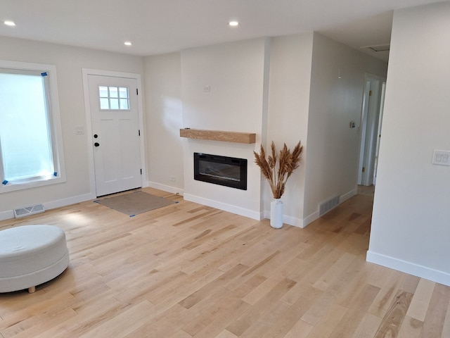 5841 Sunrise Ave, Clarendon Hills, IL 60514 - foyer entrance with recessed lighting, light wood-style floors, and a glass covered fireplace