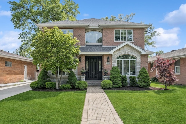 725 Park Plaine Ave, Park Ridge, IL 60068 - traditional home featuring a front lawn, roof with shingles, and stone siding