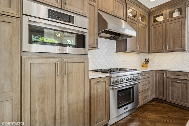 725 Park Plaine Ave, Park Ridge, IL 60068 - kitchen with stainless steel appliances, under cabinet range hood, tasteful backsplash, dark wood-type flooring, and glass insert cabinets