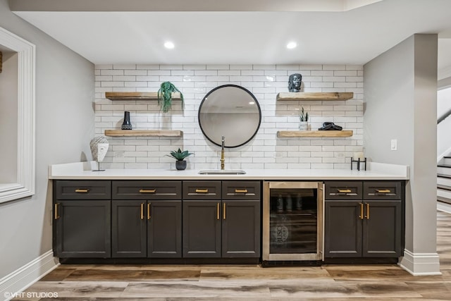 725 Park Plaine Ave, Park Ridge, IL 60068 - indoor wet bar with wine cooler, tasteful backsplash, light wood finished floors, recessed lighting, and stairway