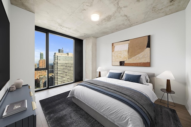 234 W Polk St Unit 2811, Chicago, IL 60607 - bedroom featuring a wall of windows, a skyline view, and wood finished floors