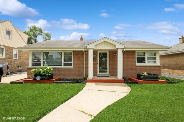 5813 Superior St, Berkeley, IL 60163 - view of front facade featuring brick siding, a front lawn, a chimney, and a shingled roof