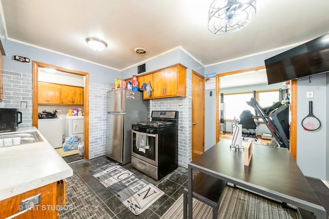 5813 Superior St, Berkeley, IL 60163 - kitchen featuring stainless steel appliances, washer and dryer, brown cabinets, light countertops, and ornamental molding