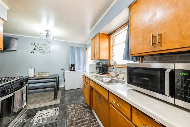5813 Superior St, Berkeley, IL 60163 - kitchen with appliances with stainless steel finishes, light countertops, brown cabinetry, decorative backsplash, and dark tile patterned flooring