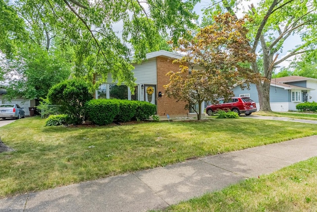189 Westwood Dr, Park Forest, IL 60466 - view of front of property featuring brick siding, a front yard, and driveway
