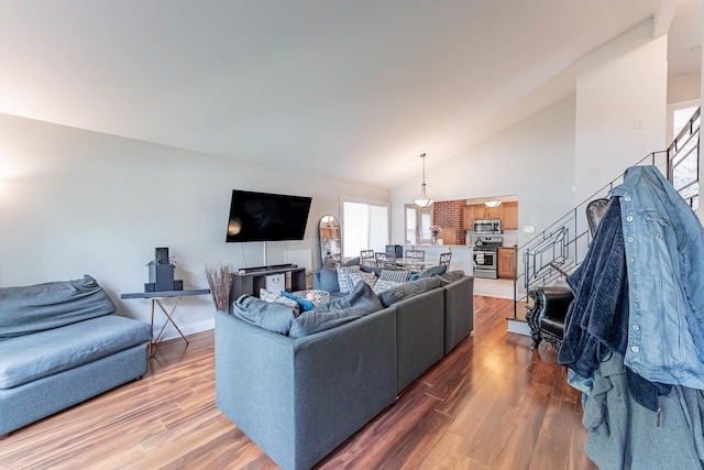 189 Westwood Dr, Park Forest, IL 60466 - living room featuring stairs, wood finished floors, and high vaulted ceiling