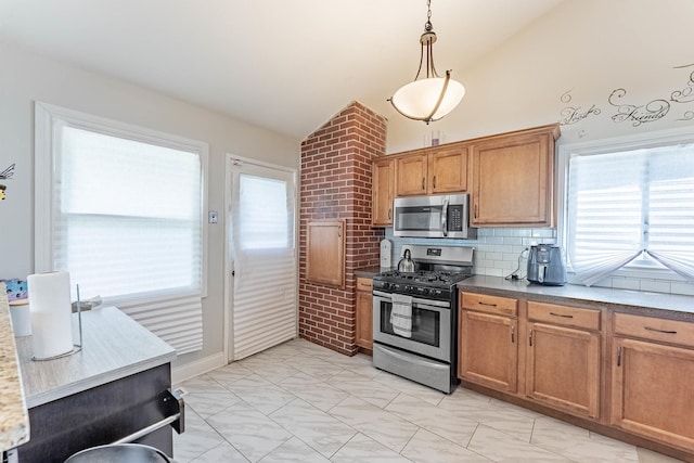 189 Westwood Dr, Park Forest, IL 60466 - kitchen featuring appliances with stainless steel finishes, brown cabinets, hanging light fixtures, decorative backsplash, and high vaulted ceiling