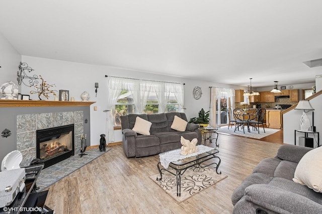 2930 Plumrose Ln, Mchenry, IL 60050 - living room featuring a fireplace, light wood-style flooring, and a chandelier
