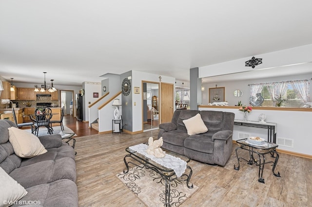 2930 Plumrose Ln, Mchenry, IL 60050 - living area with light wood finished floors, healthy amount of natural light, stairs, and a chandelier