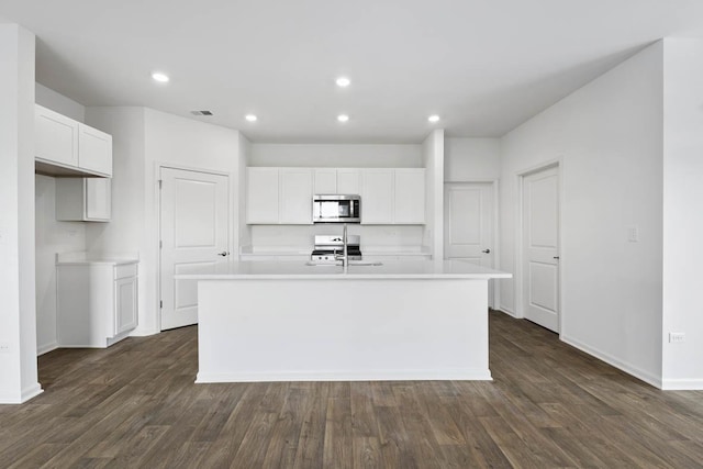 14632 S Azalia Cir, Plainfield, IL 60544 - kitchen with stainless steel microwave, an island with sink, light countertops, white cabinets, and recessed lighting